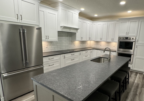 slide: Hampshire cabinets, painted maple, large island, leather granite, double oven