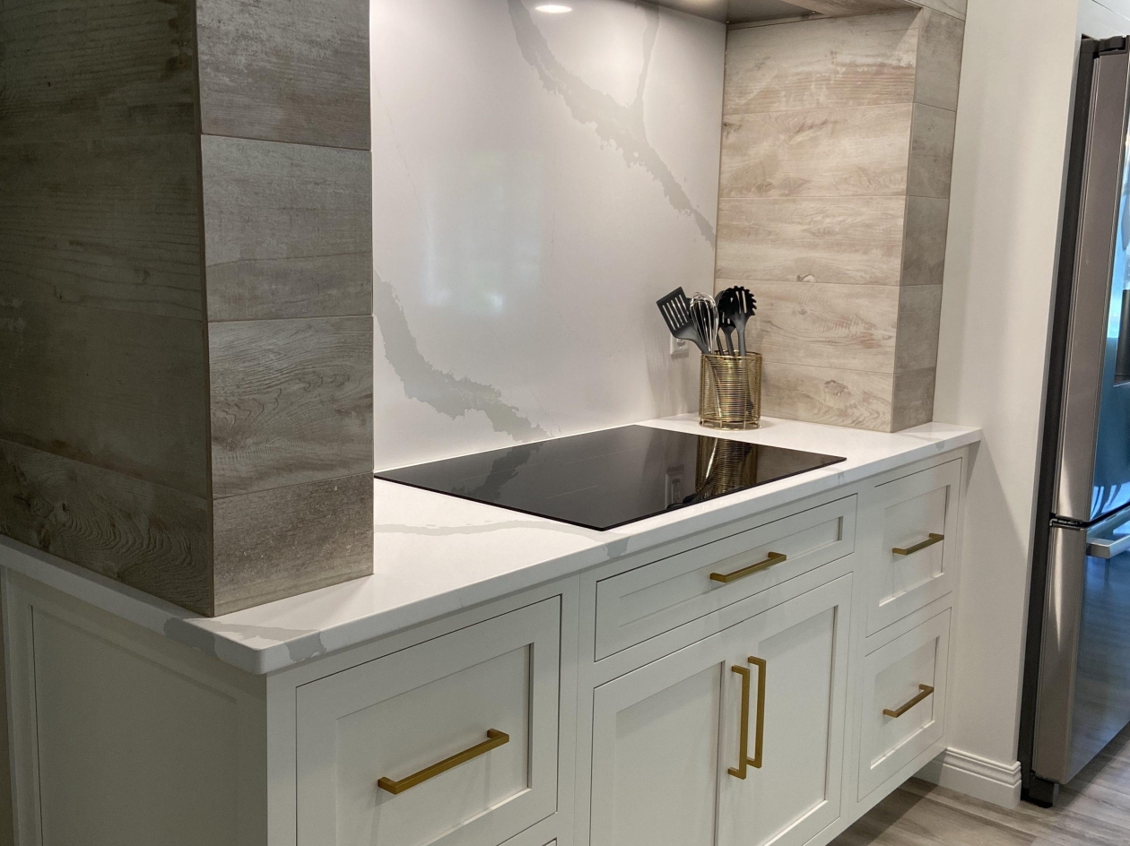 Mouser cabinetry, custom hood, painted maple, brushed gold hardware
