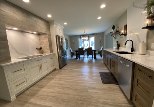 slide: Mouser Cabinetry, quartersawn oak and painted maple cabinets, custom hood, quartz tops