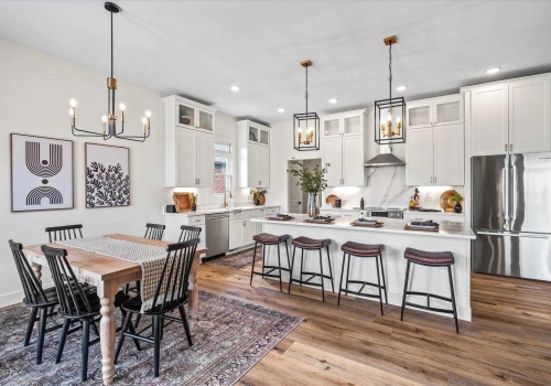 slide: Schrock cabinets, painted white, custom island, quartz tops, contractor job