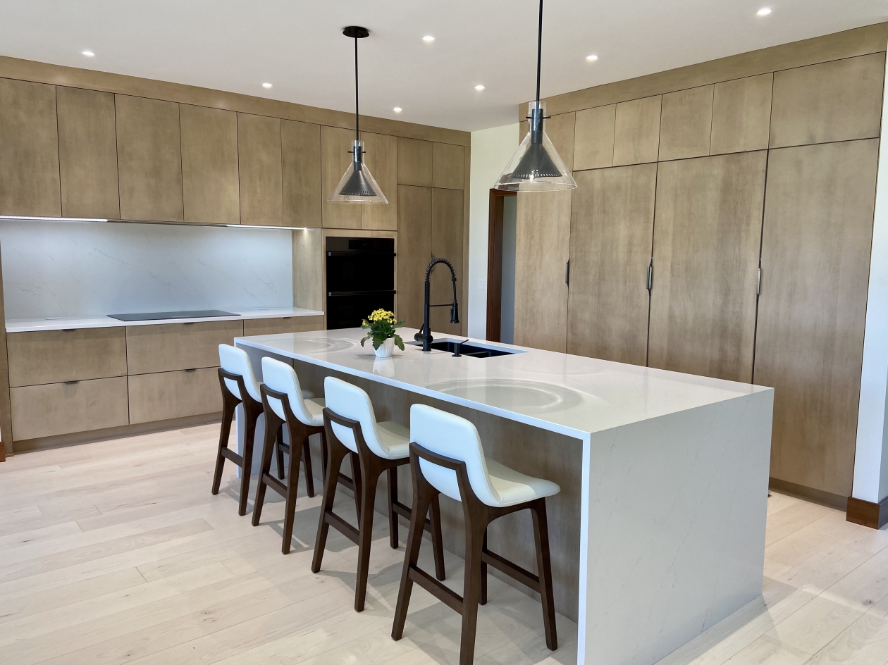 Mouser cabinetry, Euro style cabinets, waterfall countertop, custom island, pendant lighting